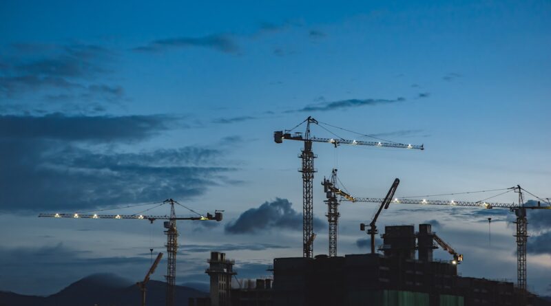several cranes above the buildings